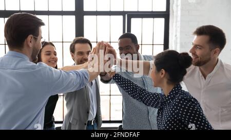 Happy motivated business team giving high five after successful ...