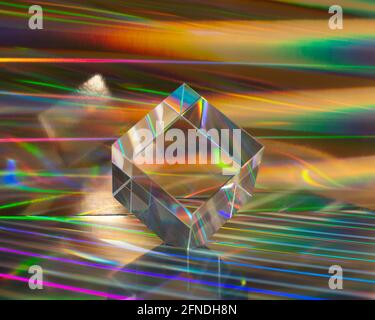 Glass cube on abstract holographic background close up. Bright vibrant abstraction Stock Photo