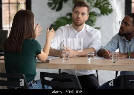 Multiethnic business team brainstorming at meeting table Stock Photo