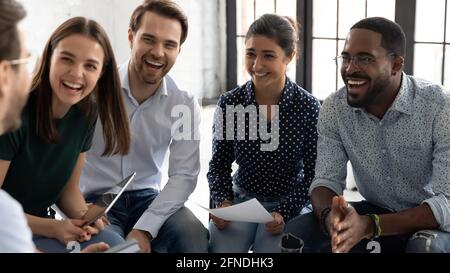 Coach or group leader telling funny story or joke Stock Photo