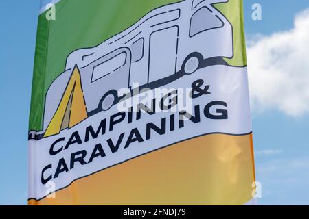 Camping and caravanning flag flying against blue sky Stock Photo