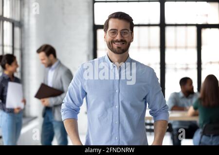 Portrait of happy millennial male business leader in modern office Stock Photo