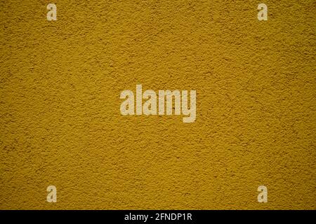 Closeup of a rough yellow surface under the lights - great for wallpapers Stock Photo