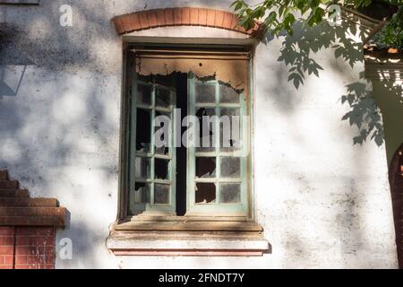 Old window with broken glass. Stock Photo