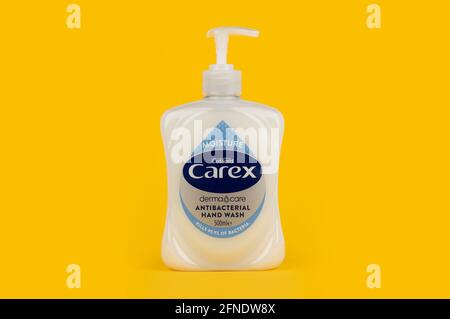 A bottle of Cussons Carex handwash shot on a yellow background. Stock Photo