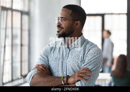 Successful African American startup leader looking out window Stock Photo