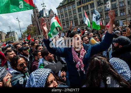 Amsterdam, Netherlands. 16th May, 2021. A protester seen shouting slogans against Israel occupation during the demonstration.The Netherlands and thousands of Dutch people gathered at the Dam Square in Amsterdam to condemn the Israeli attacks and the forced evictions of Palestinians from Sheikh Jarrah neighborhood in occupied East Jerusalem. Credit: SOPA Images Limited/Alamy Live News Stock Photo