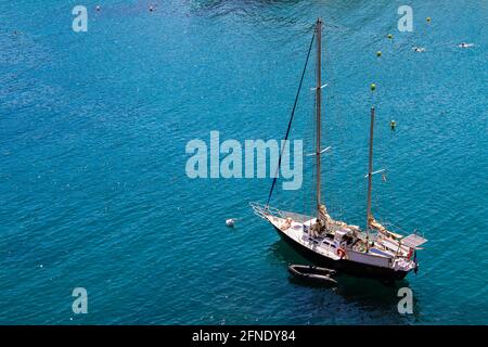 Two-masted sailing yacht anchored at sea. Stock Photo