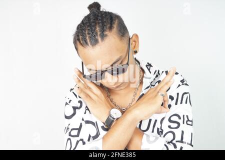 Portrait of an Indian male in a fashionable shirt and sunglasses showing Perfect gesture Stock Photo