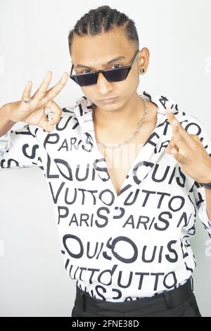 Portrait of an Indian male in a fashionable shirt and sunglasses showing Perfect gesture Stock Photo