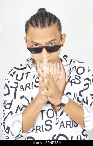 Portrait of a thoughtful Indian male in a fashionable shirt and sunglasses Stock Photo