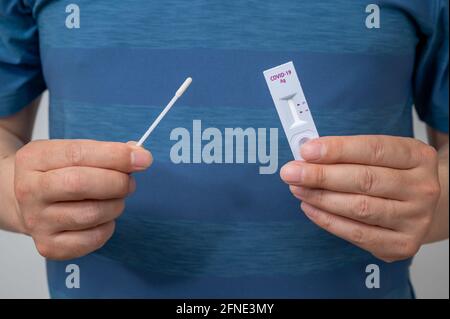Hands of men who use COVID-19 home antigen kits to test for coronavirus. Stock Photo
