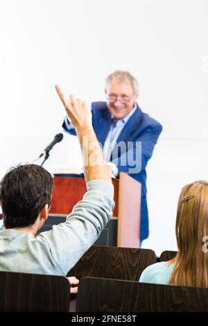 Students listening to college professor giving lecture Stock Photo