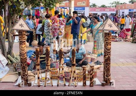 Unidentified men are selling bamboo carving artwork and bamboo sticks items at handicrafts trade fair in Kolkata, West Bengal, India on December 2019. Stock Photo