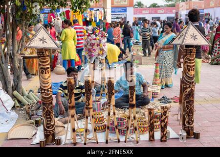 Unidentified men are selling bamboo carving artwork and bamboo sticks items at handicrafts trade fair in Kolkata, West Bengal, India on December 2019. Stock Photo