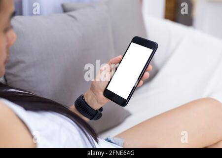 Close up hands of woman using mobile phone, cell phone in coffee shop. Hands of women holding blank empty screen smart phone in cafe. Women relax with Stock Photo