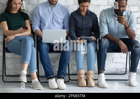 Diverse group of candidates sitting on chairs line Stock Photo