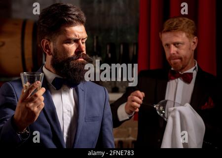 Barman at counter. Hipster in bar. Old traditional whiskey drink. Gentlemans beverage. Stock Photo