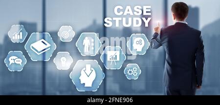Businessman pressing case study button on virtual screens. Stock Photo