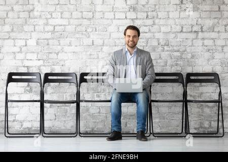 Applicant using laptop, searching vacancy on internet Stock Photo