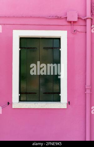 Pink wall with window, closed shutters, colorful house wall, colorful facade, Burano Island, Venice, Veneto, Italy Stock Photo