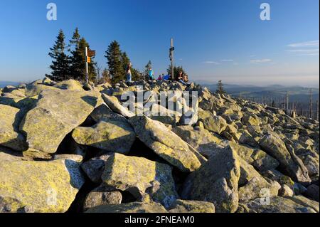 Lusen, 1373 meters, sea of granite blocks on the summit, summit cross with (hiker), evening, October, Bavarian Forest National Park, Bavaria, Germany Stock Photo