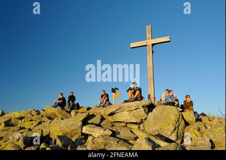 Lusen, 1373 meters, sea of granite blocks on the summit, summit cross with (hiker), evening, October, Bavarian Forest National Park, Bavaria, Germany Stock Photo