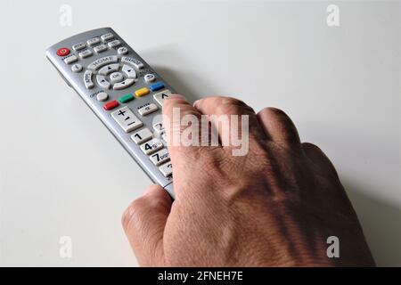 tv remote control in hand Stock Photo