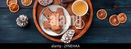 Spekulatius and Elisen, German Christmas gingerbread biscuits, panoramic flat lay shot on a dark blue background Stock Photo
