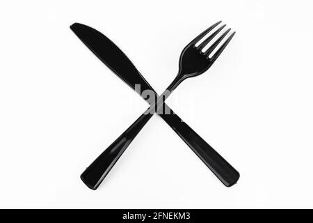 Black table fork and knife crossed on white background. Stock Photo