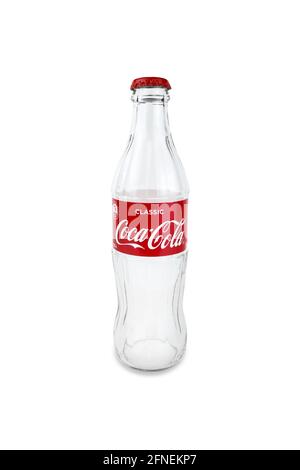 Empty glass bottle of coca cola with red cap and label, 0.33 l, isolated on white background. - Russia, St. Petersburg, February 2021 Stock Photo