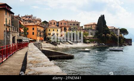 Cloudy and sunny day of the Como Lake with the village of Varenna, Italy, with soft sunlight Stock Photo