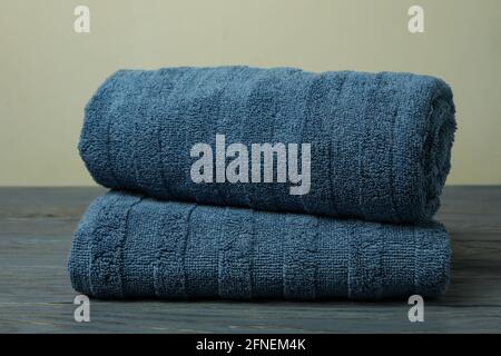 Clean folded towels on gray wooden table, close up Stock Photo