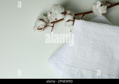 Clean folded towels and cotton on white background Stock Photo