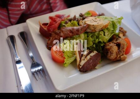 mixed meat salad meal in Toulouse, Haute-Garonne, Occitanie, South of France Stock Photo