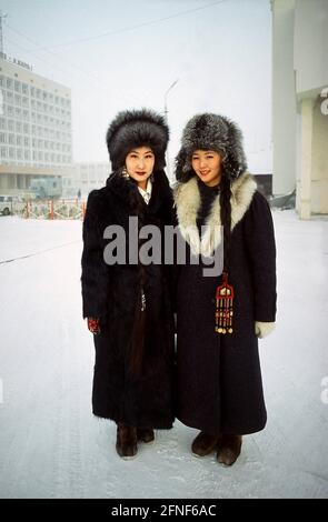 Two Yakut women in thick winter clothing and fur hats. [automated  translation] Stock Photo