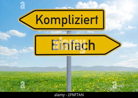 Two direction signs - Complicated or Easy - Einfach oder Kompliziert (german) Stock Photo