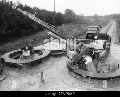 Soldiers of a Bundeswehr tank crew on maneuver. In the foreground, the ...