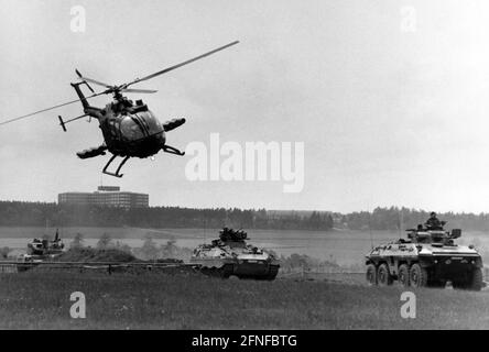 Exercise of the army pilots with the anti-tank helicopter Bo 105 with anti-tank missiles PAH 1. In the background scout tank Luchs and infantry fighting vehicle Puma. [automated translation] Stock Photo