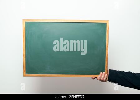 hand holding a blank blackboard, copyspace for text Stock Photo