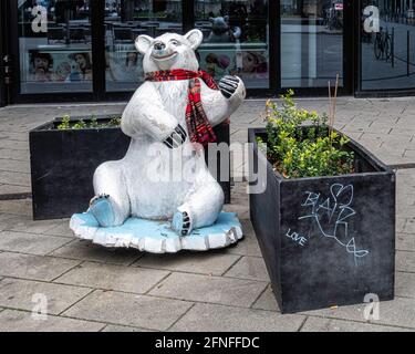 Seated  white buddy  bear wearing tartan scarf at Alexanderplatz, Mitte, Berlin Stock Photo