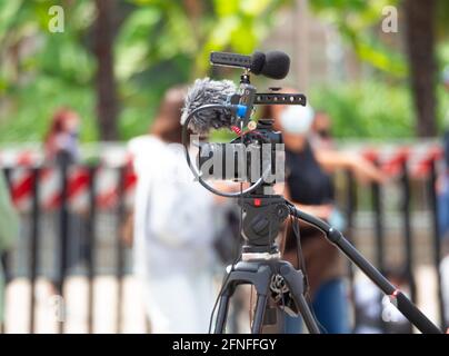 outdoor video shooting made using a reflex with microphone on tripod. blurred background. Stock Photo