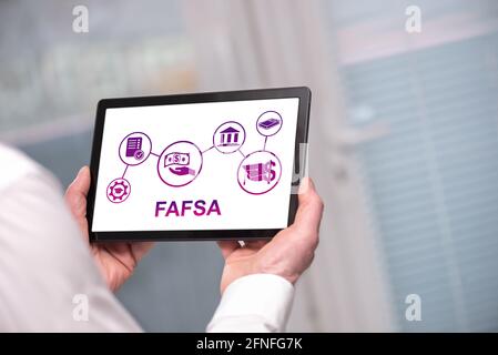 Fafsa concept shown on a tablet held by a man Stock Photo