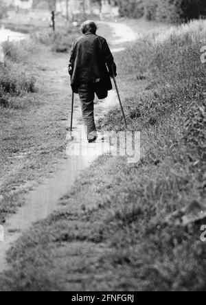 A war invalid during a walk in the field. [automated translation] Stock Photo