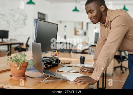African businessman working on a laptop at his office desk Stock Photo