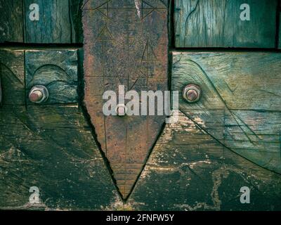 Detail of an arrow over a vintage blue wood texture Stock Photo