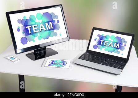 Team concept shown on different information technology devices Stock Photo