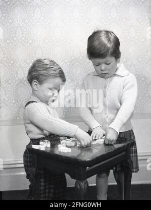 1950s Smiling Boy And Girl Brother And Older Sister Ladling Bread