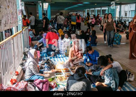 Hong Kong - November, 2019: Women, maids, domestic workers, mostly from the phillipines and indonesia gather outside on sunday, their day off in Hong Stock Photo