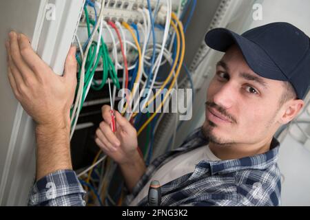 technician measures the signal level in a fiber optic cable Stock Photo